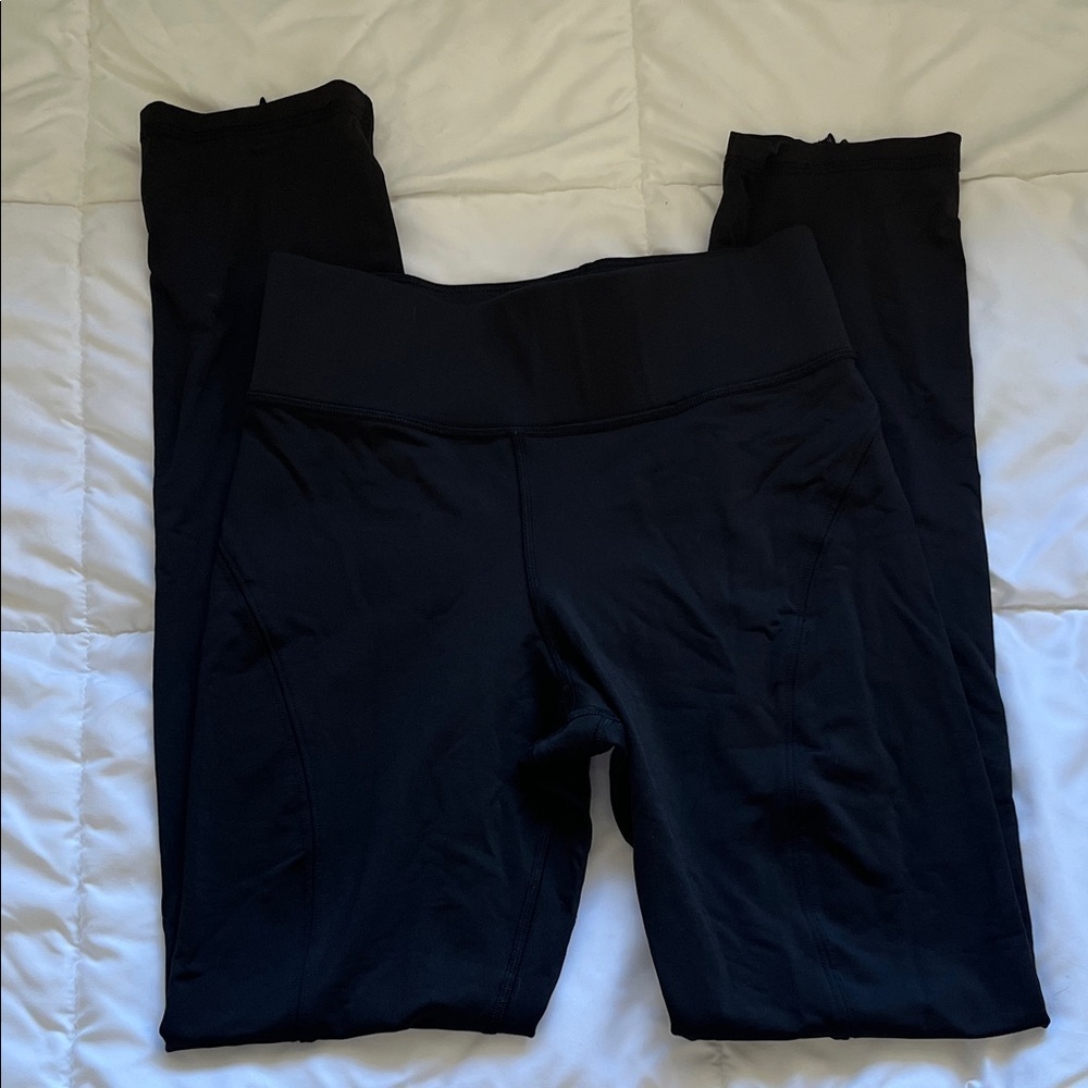 Michi Black Leggings with zipper bottoms. Size Small